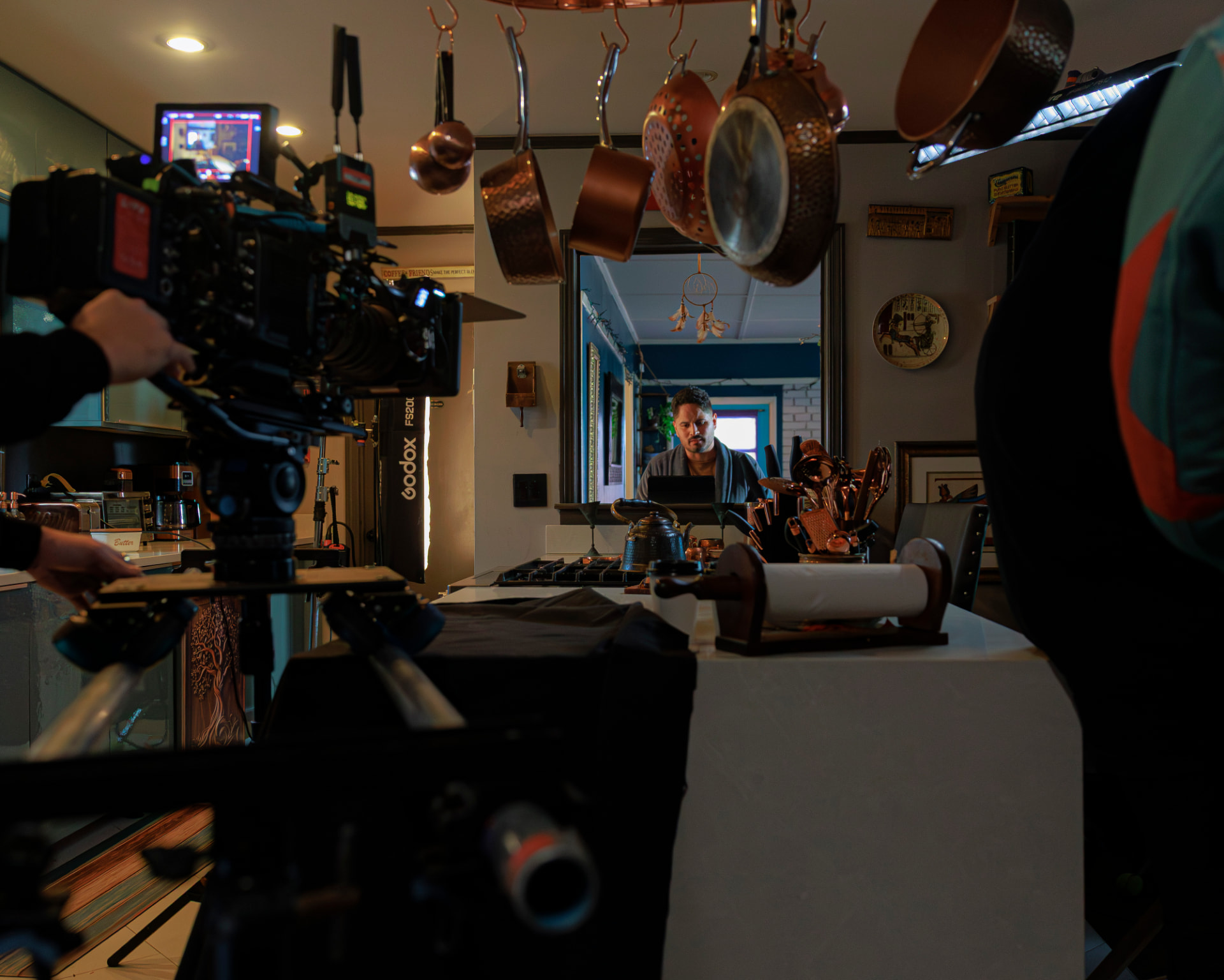 Wide interior setup with camera and lighting on the kitchen set